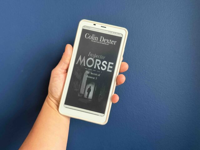 The Secret of Annexe 3 ebook cover, held by my hand against a blue background.