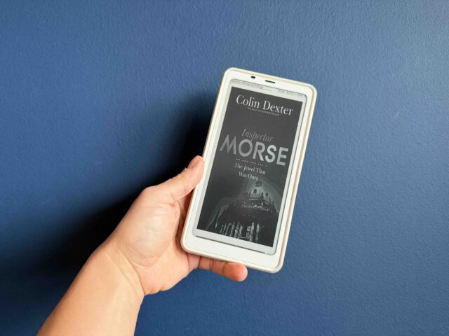 Cover of The Jewel is Dead ebook held by my hand against a navy background